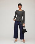 Woman wearing Addy Side-Knot Top in charcoal rib knit with long sleeves and asymmetrical side knot detail.
