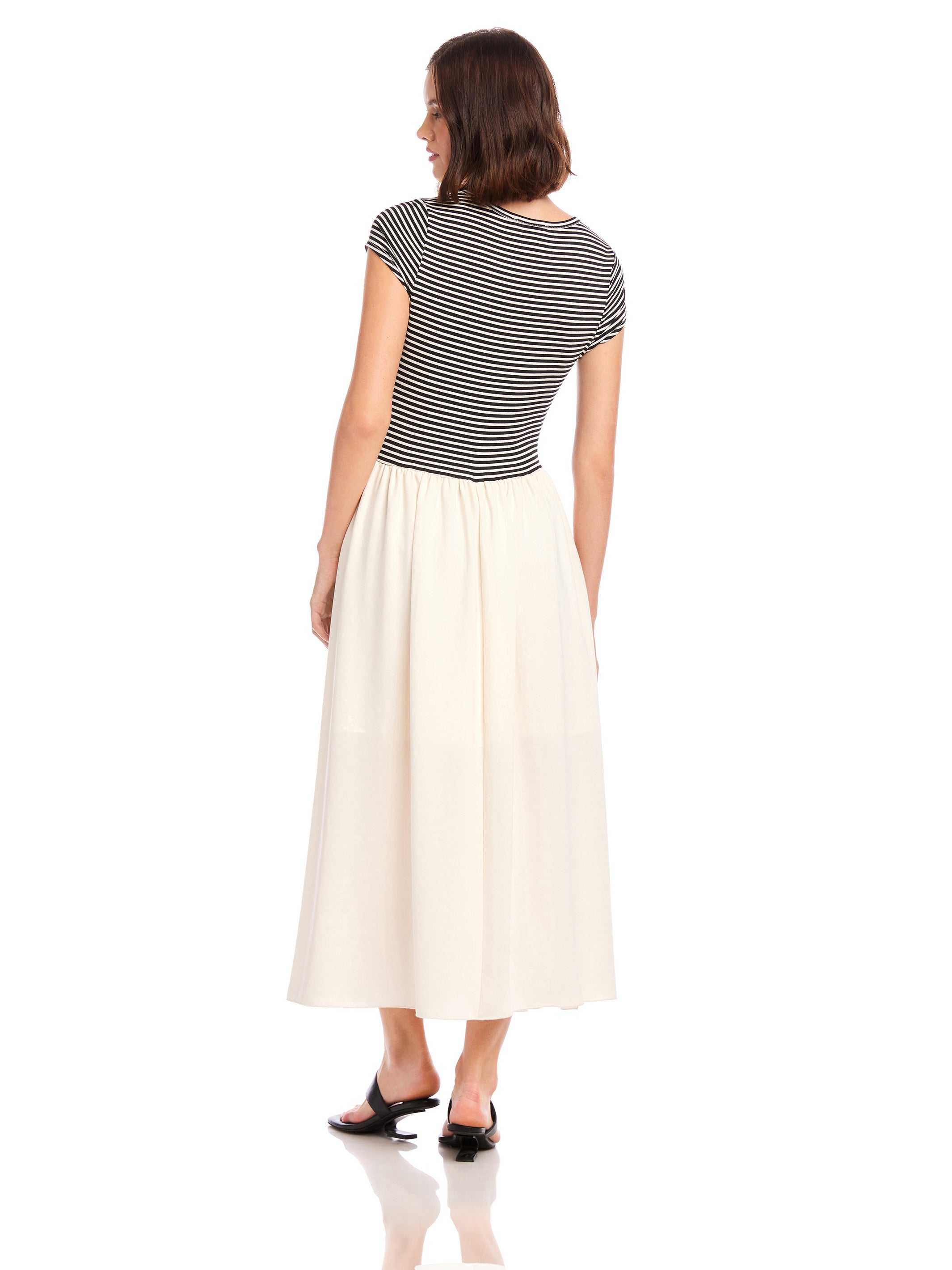 Woman wearing Contrast Hem Sylvie Dress with black and white striped jersey top and solid white skirt, viewed from the back.