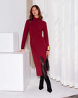Model wearing brick red Tasha Turtleneck Midi Dress with fold-over collar, long sleeves, side slit, and slim fit silhouette