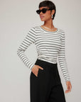 Woman wearing Steff Side Shirred Top with navy stripes and black pants, styled with sunglasses and earrings
