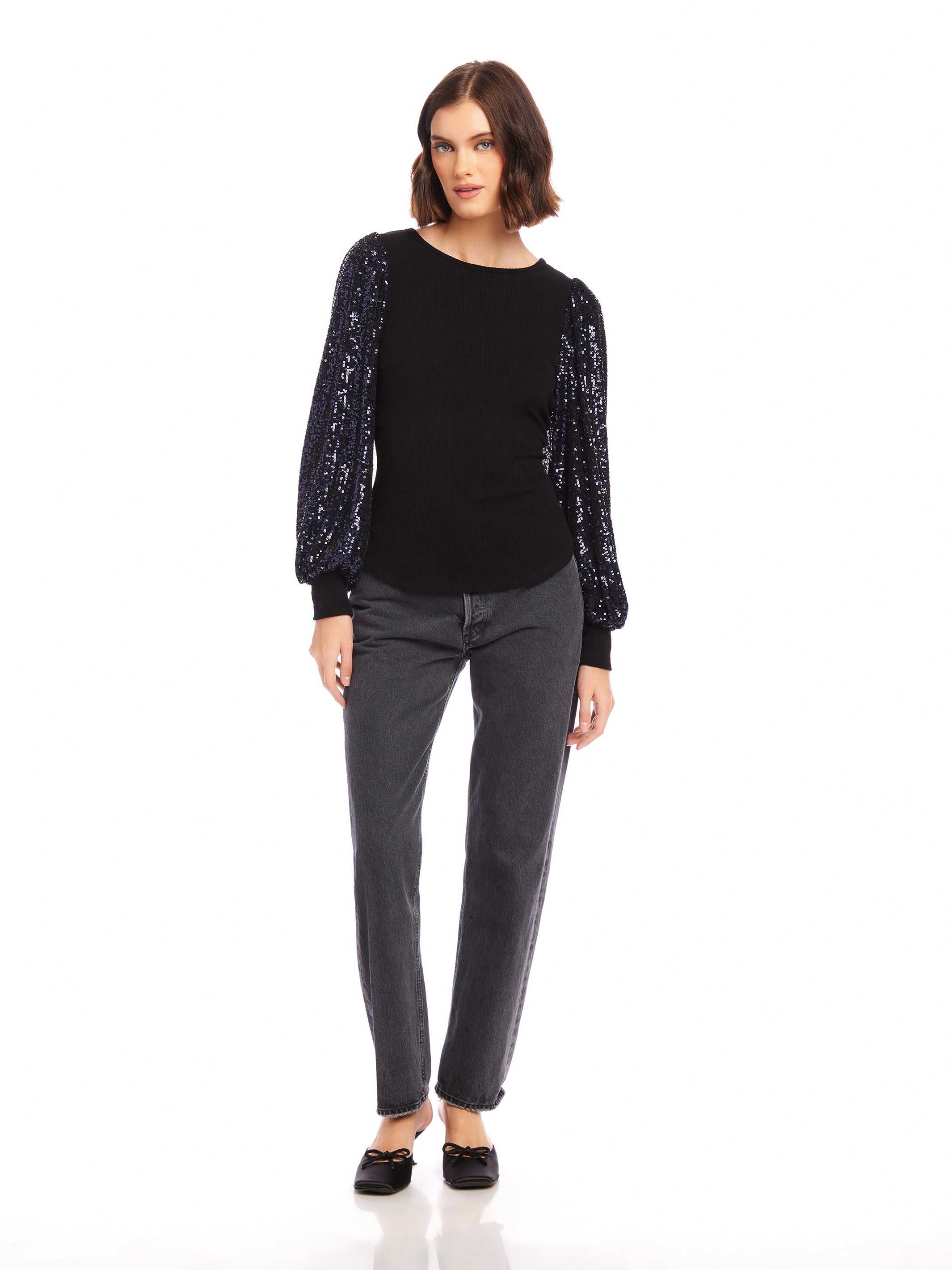 Black sequin bishop sleeve top with crew neck and fitted body worn with gray jeans and black flats