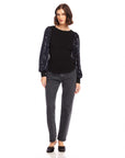 Black sequin bishop sleeve top with crew neck and fitted body worn with gray jeans and black flats