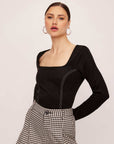 Black faux suede stitch top with long sleeves and square neck worn by a model