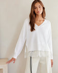 Camila Lace Layered Sweater in white with a V-neck, long sleeves, and a floral lace hem overlay.