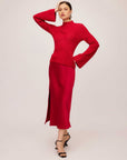 Woman wearing a red Brielle Flare Sleeve Sweater with a mock neck and ribbed knit detail paired with a matching red skirt and black heels.