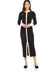 Black and white button-down Maves Dress with front slit and long sleeves modeled on woman