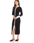 Black and white button-down Maves Dress with front slit and long sleeves made of cozy sweater material.