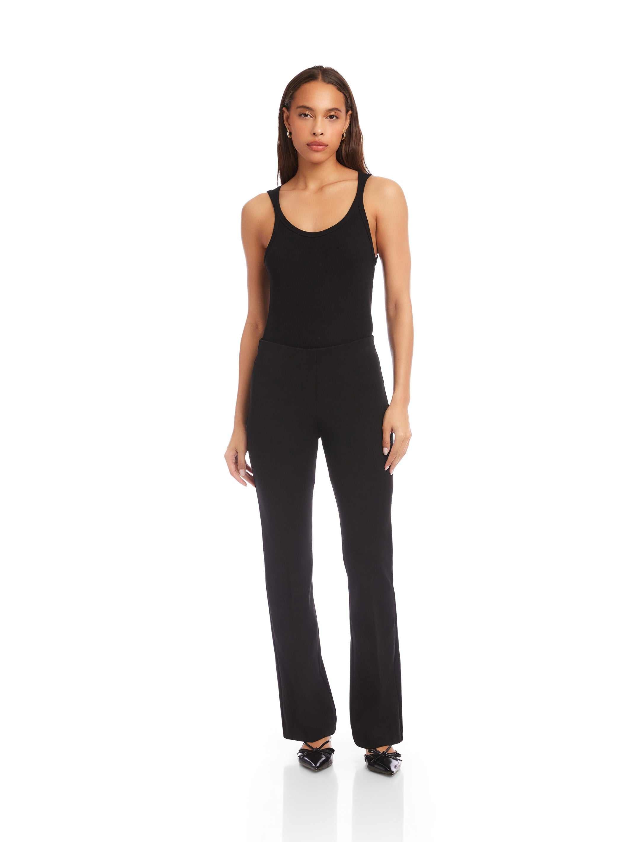 Woman wearing black City Bootcut Pants with elastic waistband and pull-on design, styled for polished everyday wear