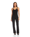 Woman wearing black City Bootcut Pants with elastic waistband and pull-on design, styled for polished everyday wear