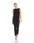 Woman wearing black Jane Ankle Zip Pants with slim fit and sleeveless black top walking on white background