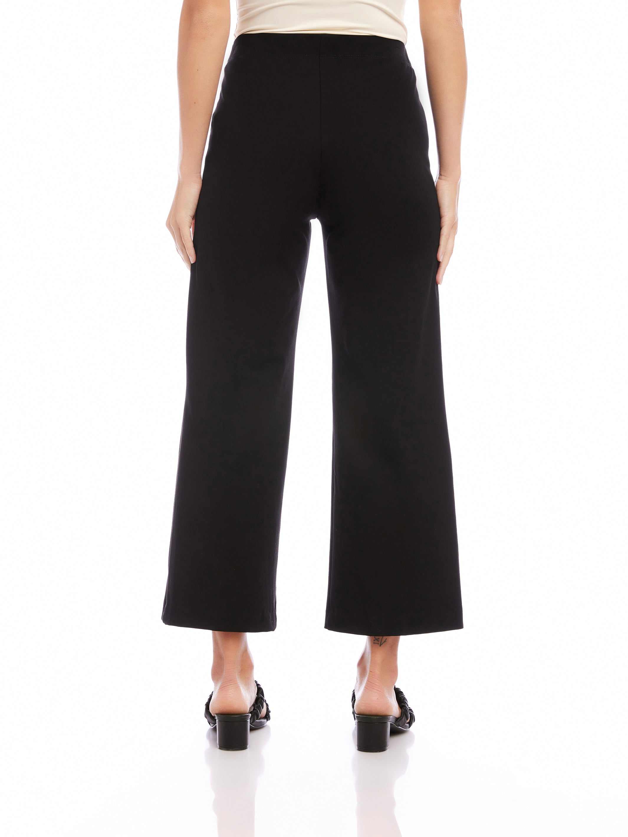 Black wide-leg cropped pants made of double stretch twill with an elastic waistband, shown from the back.