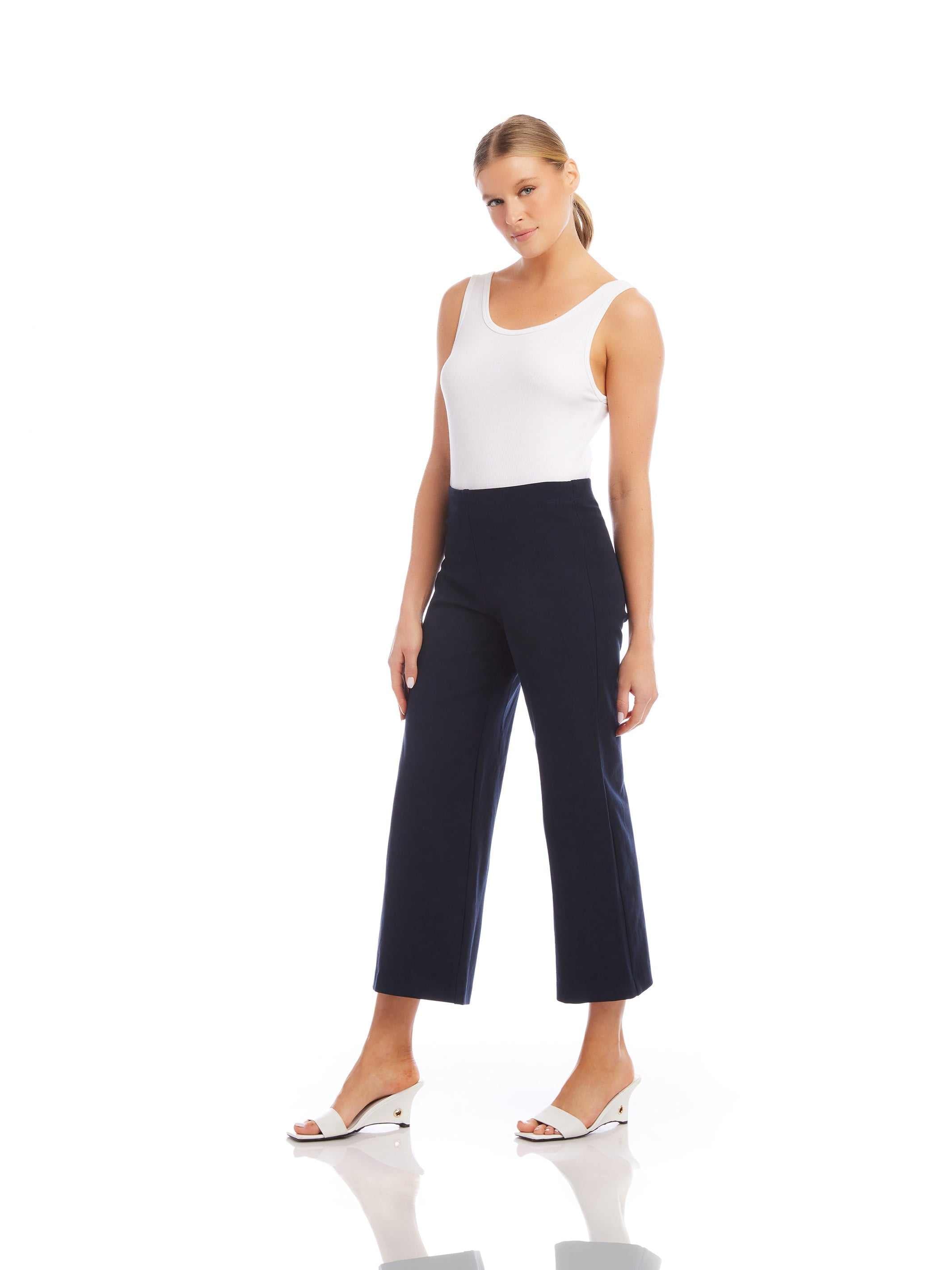 Woman wearing navy wide-leg cropped pants with elastic waistband and white tank top