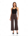 Woman wearing Rylee Crop Pants in dark brown wide-leg cropped style with button-zipper closure and belt loops