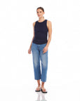 woman wearing navy Side Shirred Tank and blue jeans standing on white background