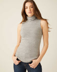 Woman wearing a slim fit gray sleeveless turtleneck rib-knit top with shirttail hem