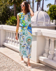 Woman wearing sleeveless Sami top with botanical scarf print and adjustable waist tie, paired with matching skirt outdoors