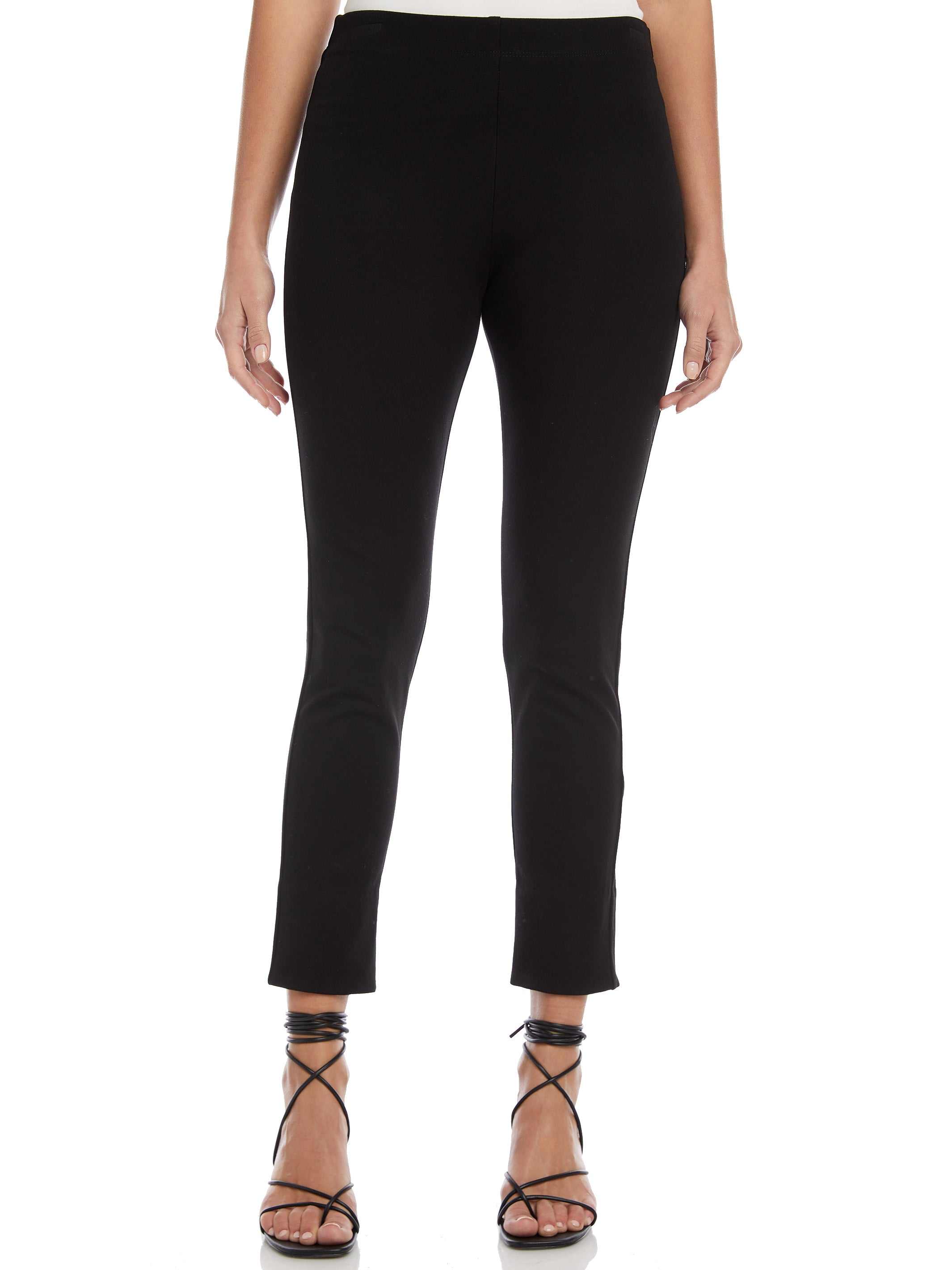 Black ankle slit pants with elastic waistband and slim fit, styled with strappy heels