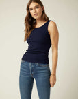 Woman wearing a navy sleeveless rib-knit Everyday Rib Tank with scoop neck and straight hem paired with blue jeans