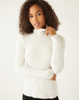 Woman wearing a white brushed rib-knit long sleeve turtleneck sweater