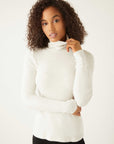 woman wearing white rib-knit long sleeve turtleneck sweater