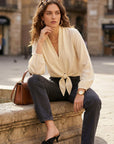 Capri Tie-Front Blouse in breathable cupro with V-neck and long sleeves, styled with elastic cuffs and tie front detail