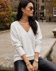 Ash light heather gray Deliana Oversized Sweater with V-neck and ribbed cuffs, perfect for cool nights.