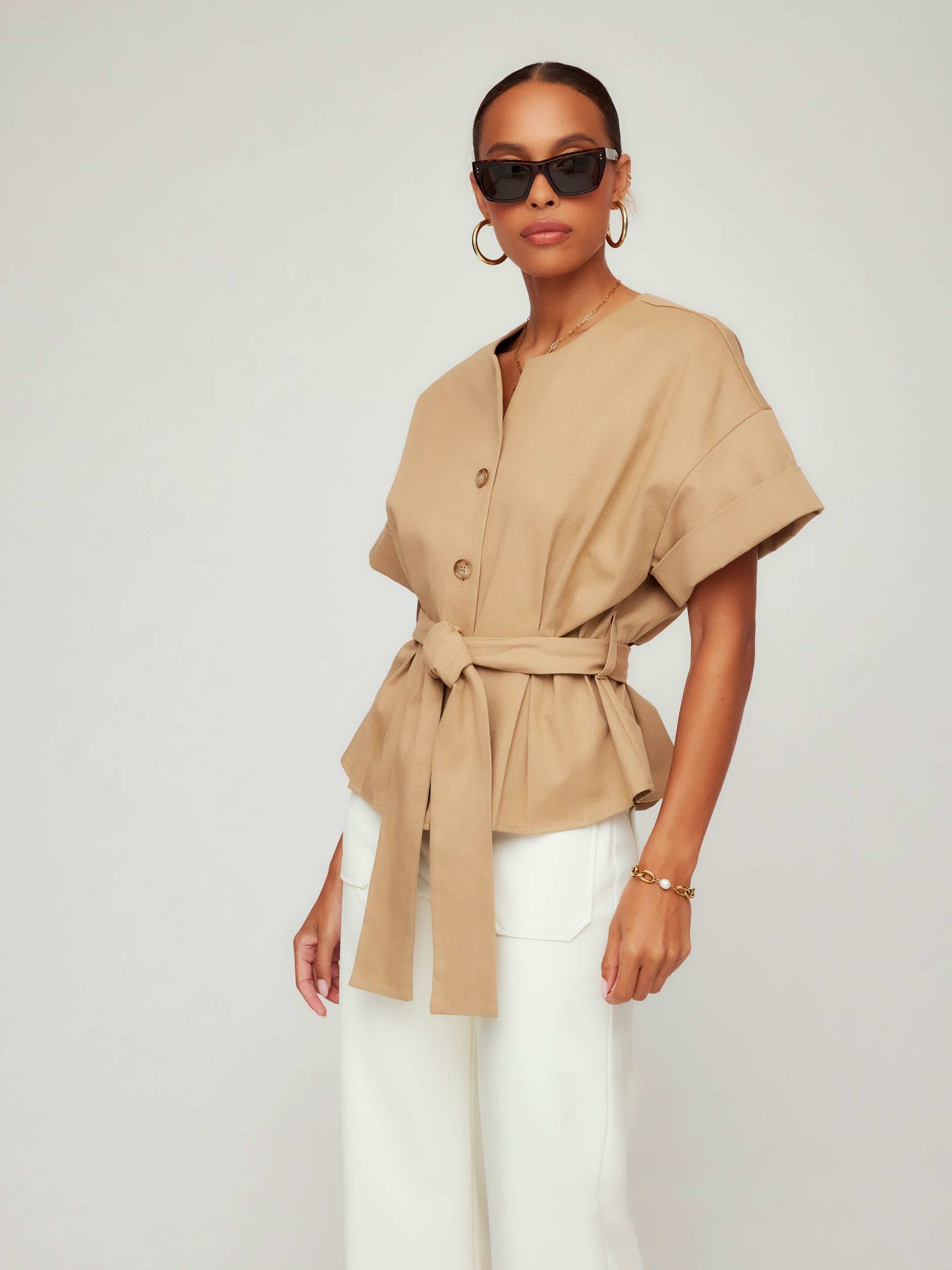 Woman wearing a Kai Belted Button-Up Top with short cuffed sleeves and tortoise buttons