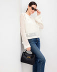 Liv Crochet Sweater with semi-sheer open-weave design, flared sleeves, and back keyhole closure.