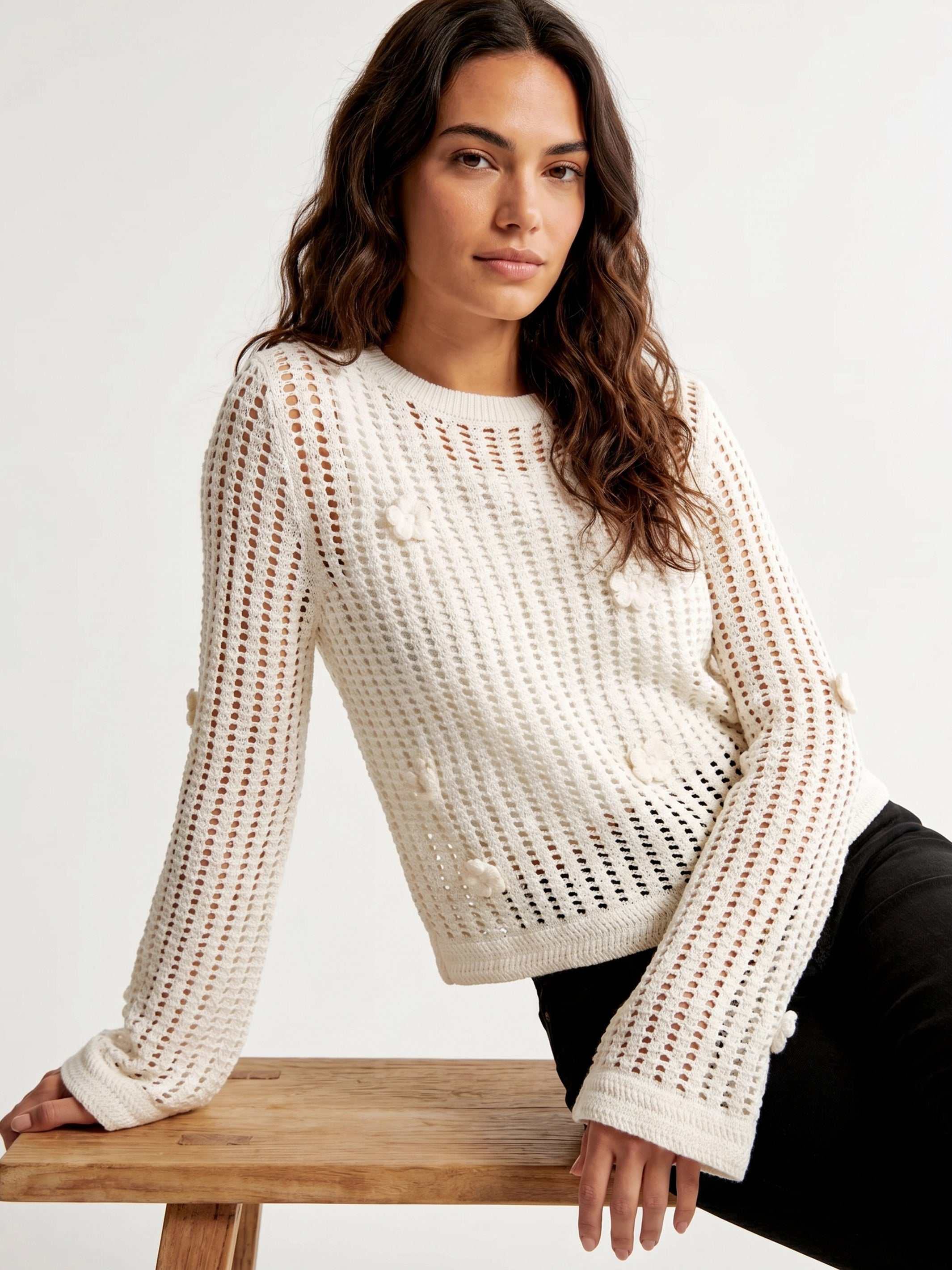 Semi-sheer Liv Crochet Sweater with flared sleeves and back keyhole closure, featuring delicate flower details.