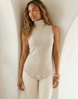 Sleeveless turtleneck top in soft brushed rib fabric with shirttail hem and stretch fit