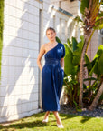 Woman wearing navy blue Abilene One-Shoulder Midi Dress with puff sleeve and elastic waistband outdoors