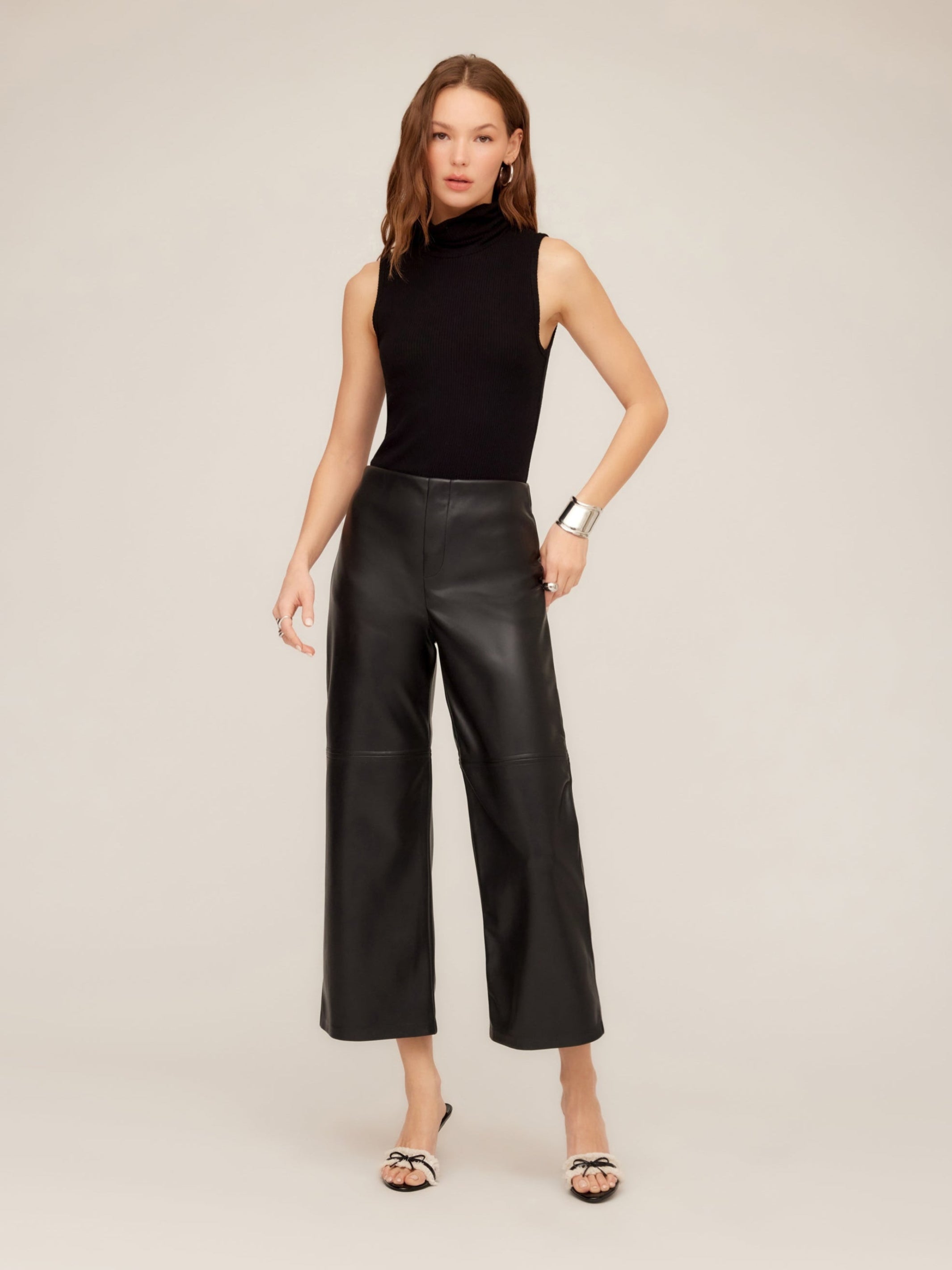 Woman wearing faux leather cropped pants with wide-leg and high-rise pull-on style.