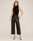 Woman wearing faux leather cropped pants with wide-leg and high-rise pull-on style.